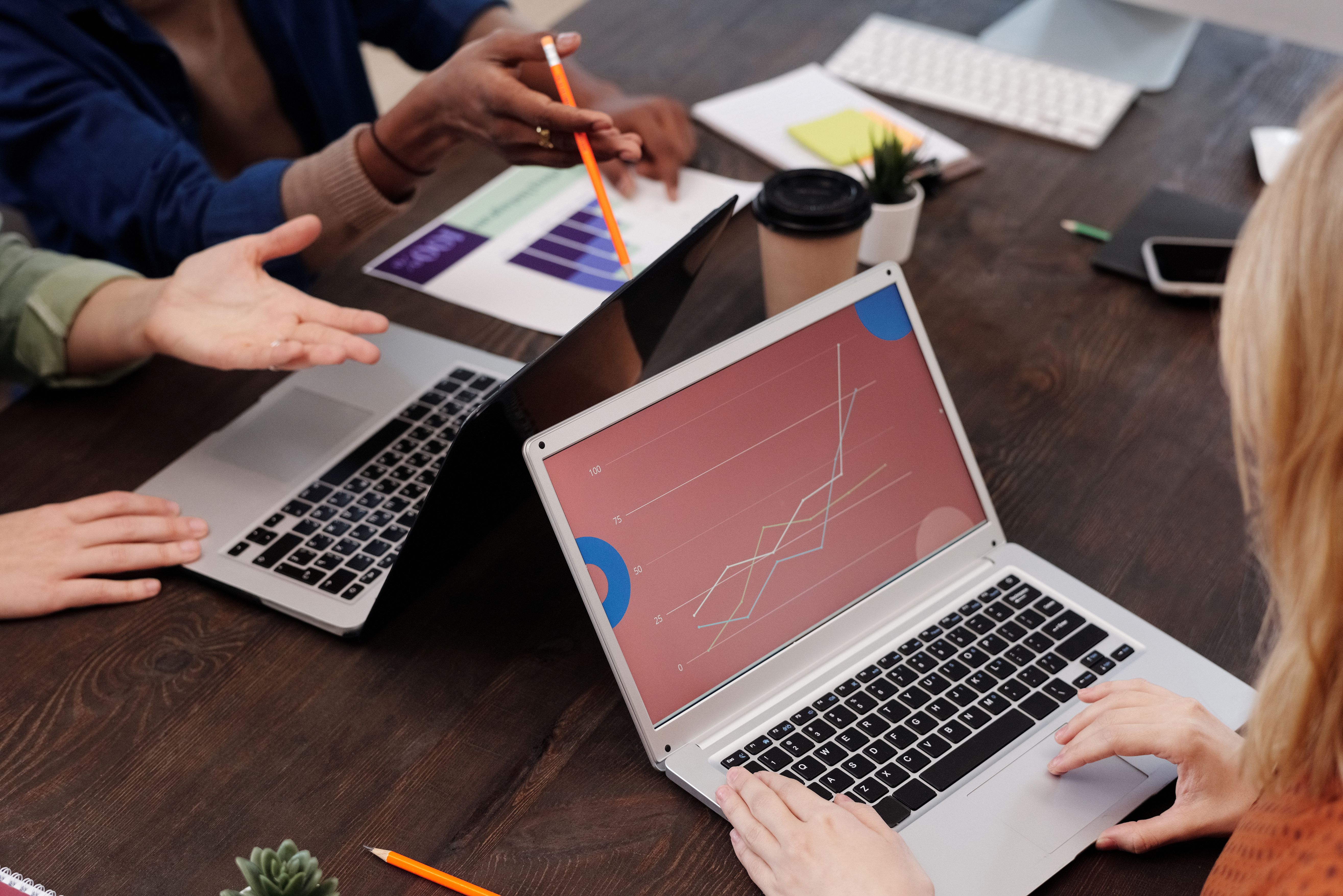Two colleagues working through a problem together at a whiteboard